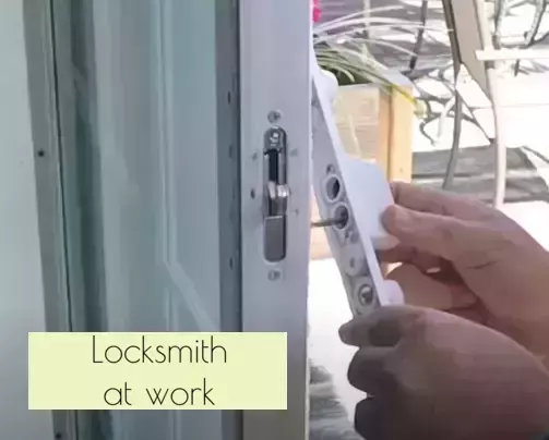 Locksmith at work: fixing sliding door lock